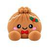Cookie, a gingerbread plush dumpling with a holly sprig