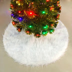 White plush tree skirt under a lit Christmas tree