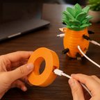 Two hands tucking a white USB cable into the side slot of an orange slice to wind it